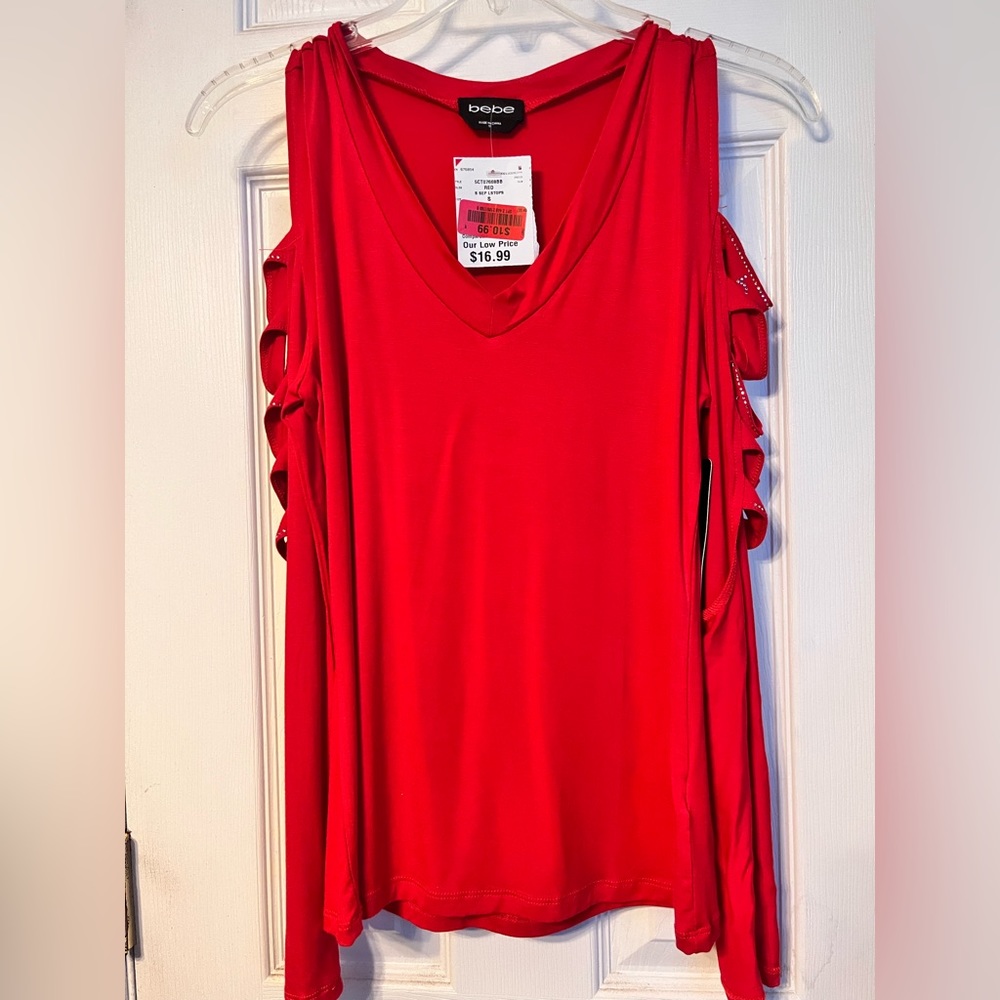 Red full sleeve top in size small. Has fancy cuts in the sleeves